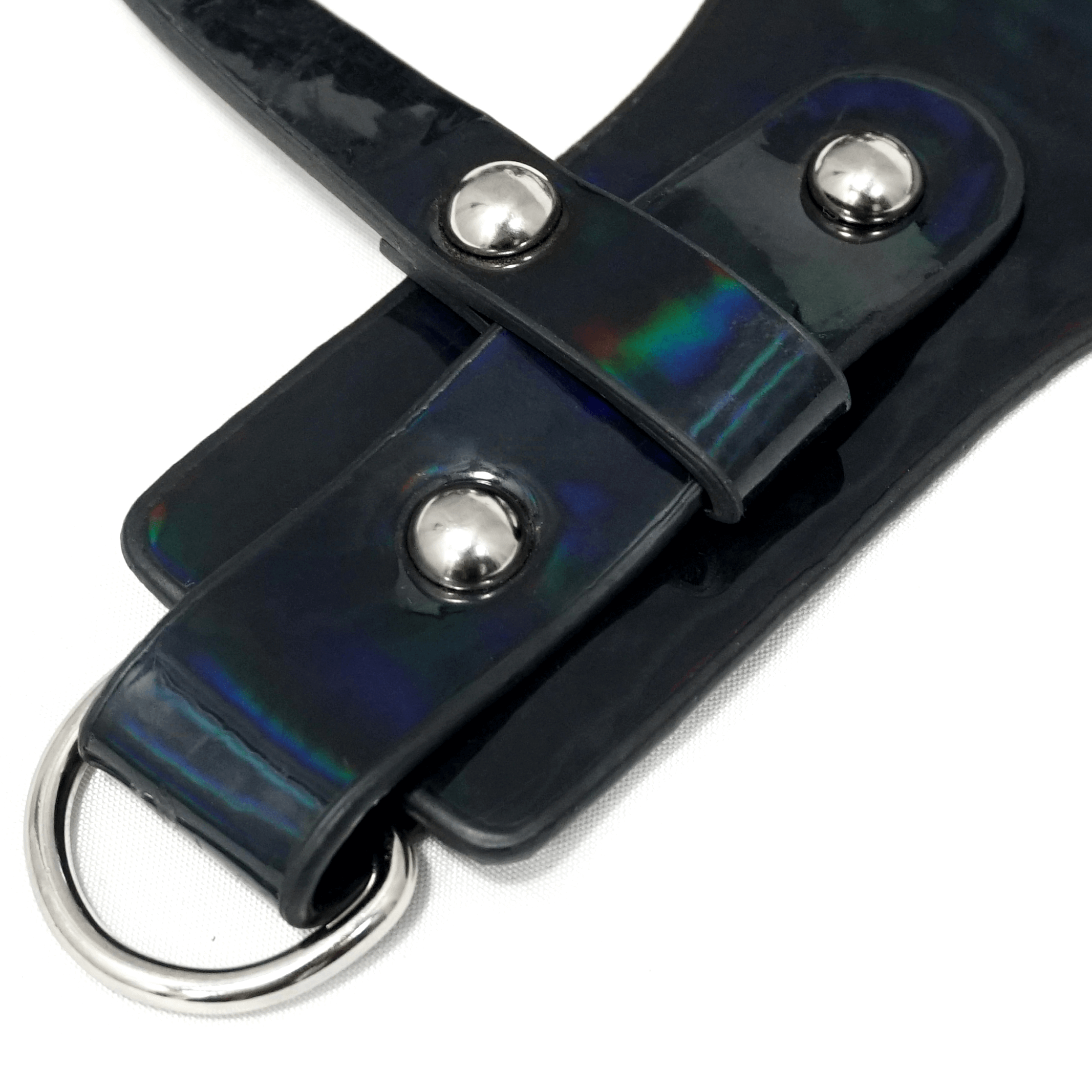 Close-up of a women's gothic faux leather body harness featuring silver fittings and adjustable straps.