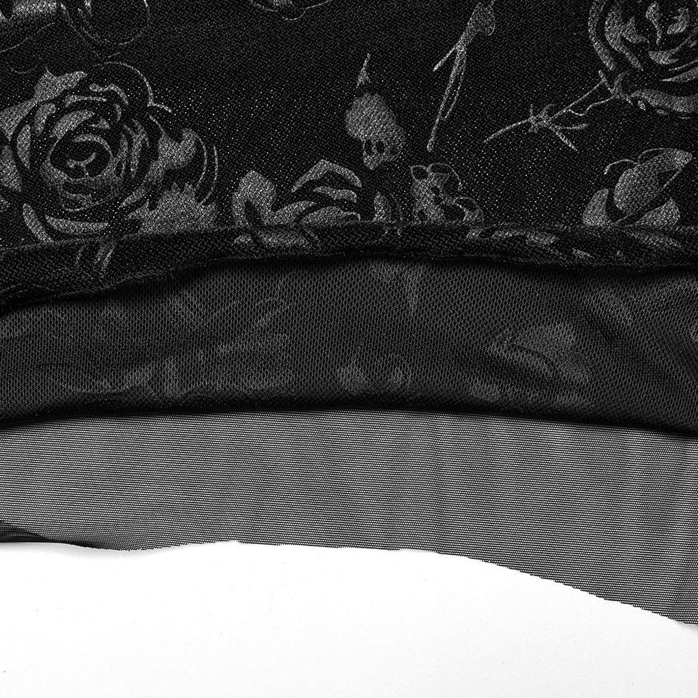 Close-up of floral black velvet fabric with mesh detailing, highlighting gothic elegance and intricate rose patterns.