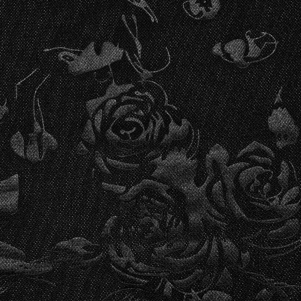 Close-up of black velvet fabric with embossed roses and gothic skulls, perfect for a dark, elegant style.