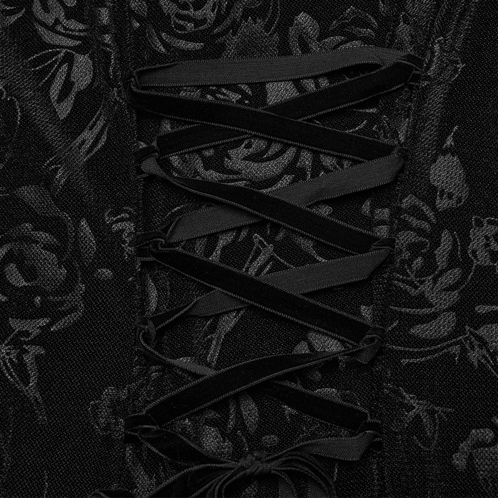 Close-up of black velvet dress detailing with rose mesh fabric and lace-up corset design.