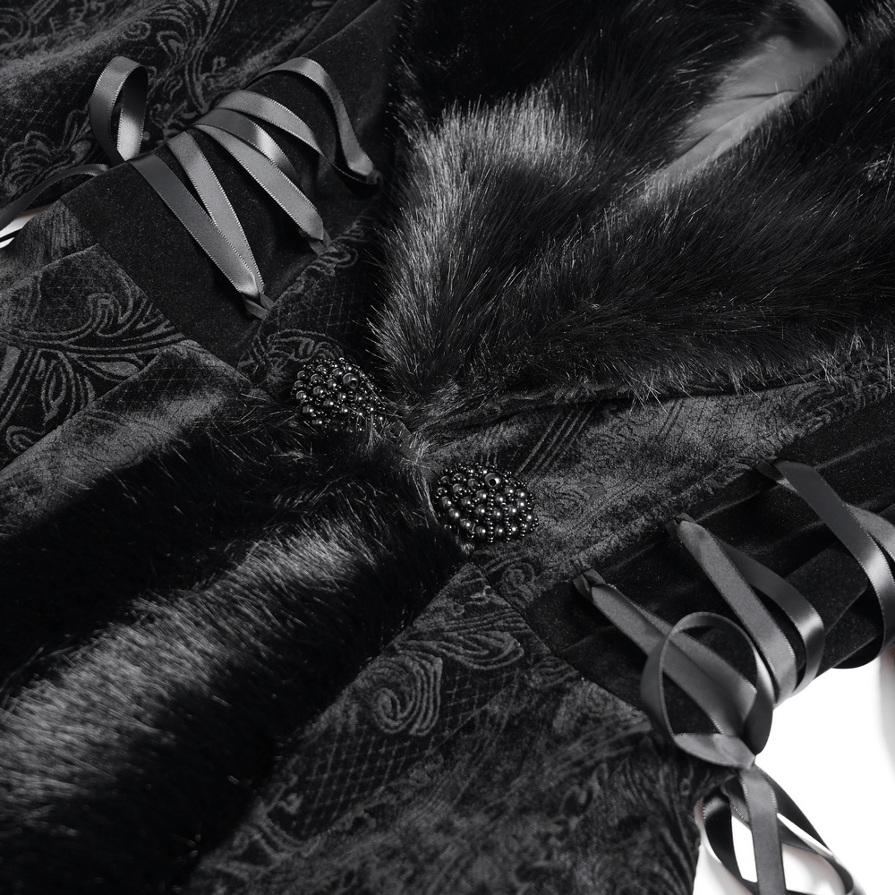 Close-up of an elegant black coat with fur collar, lace-up waist details, and intricate paisley patterns.