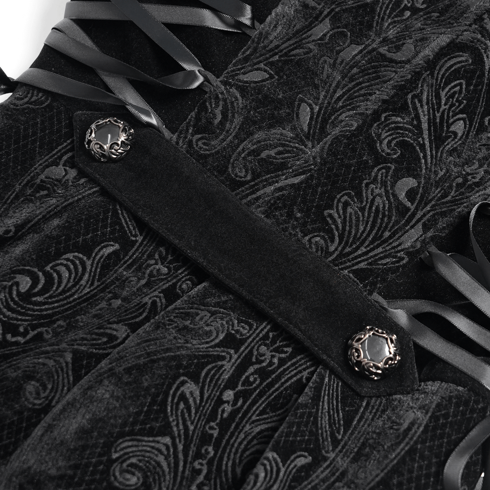 Close-up of elegant lace-up waist details and paisley patterns on a black Gothic coat, showcasing luxurious design.