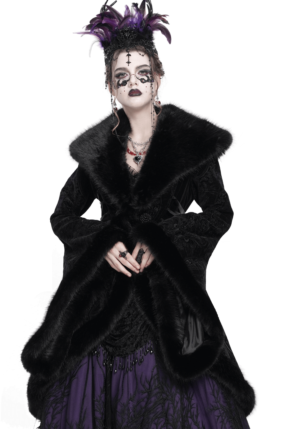 Elegant woman in a black fur-trimmed coat, showcasing Gothic style with lace-up waist details and dramatic makeup.