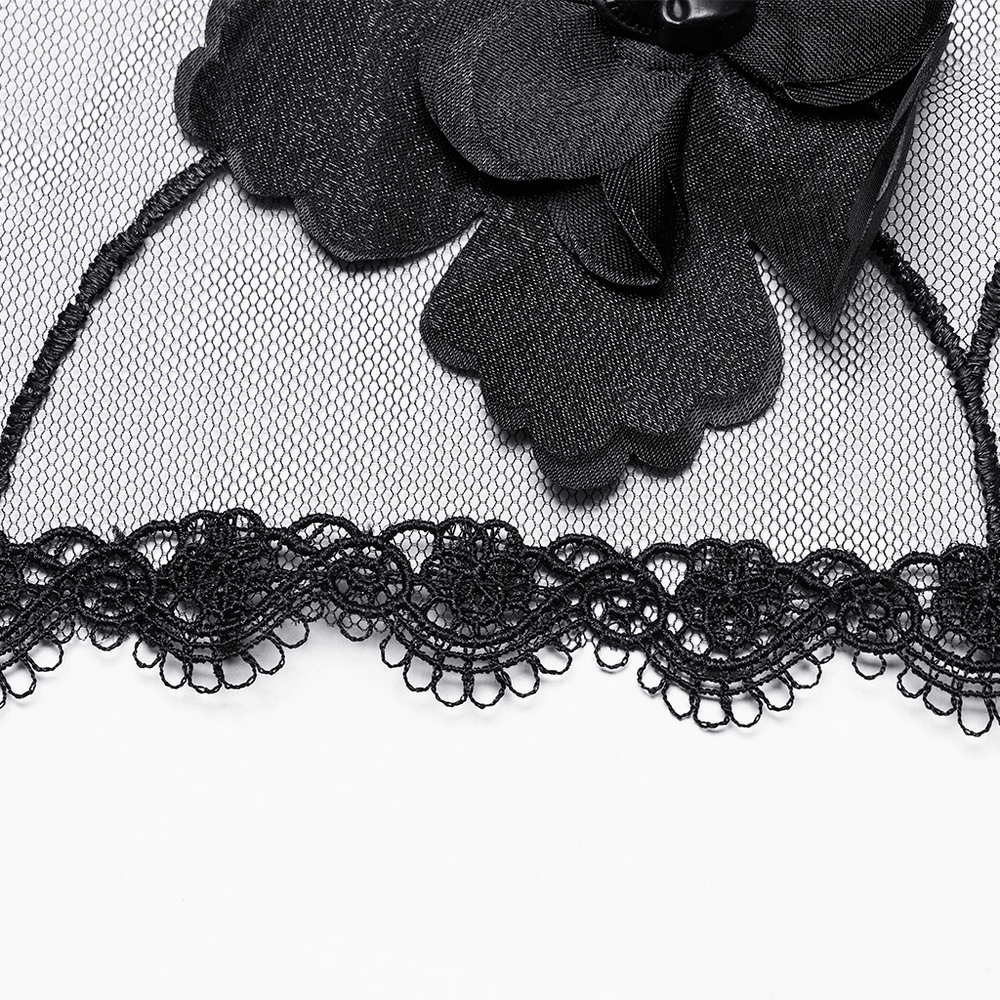 Close-up of a black gothic veil with 3D flower accents and intricate lace trim.