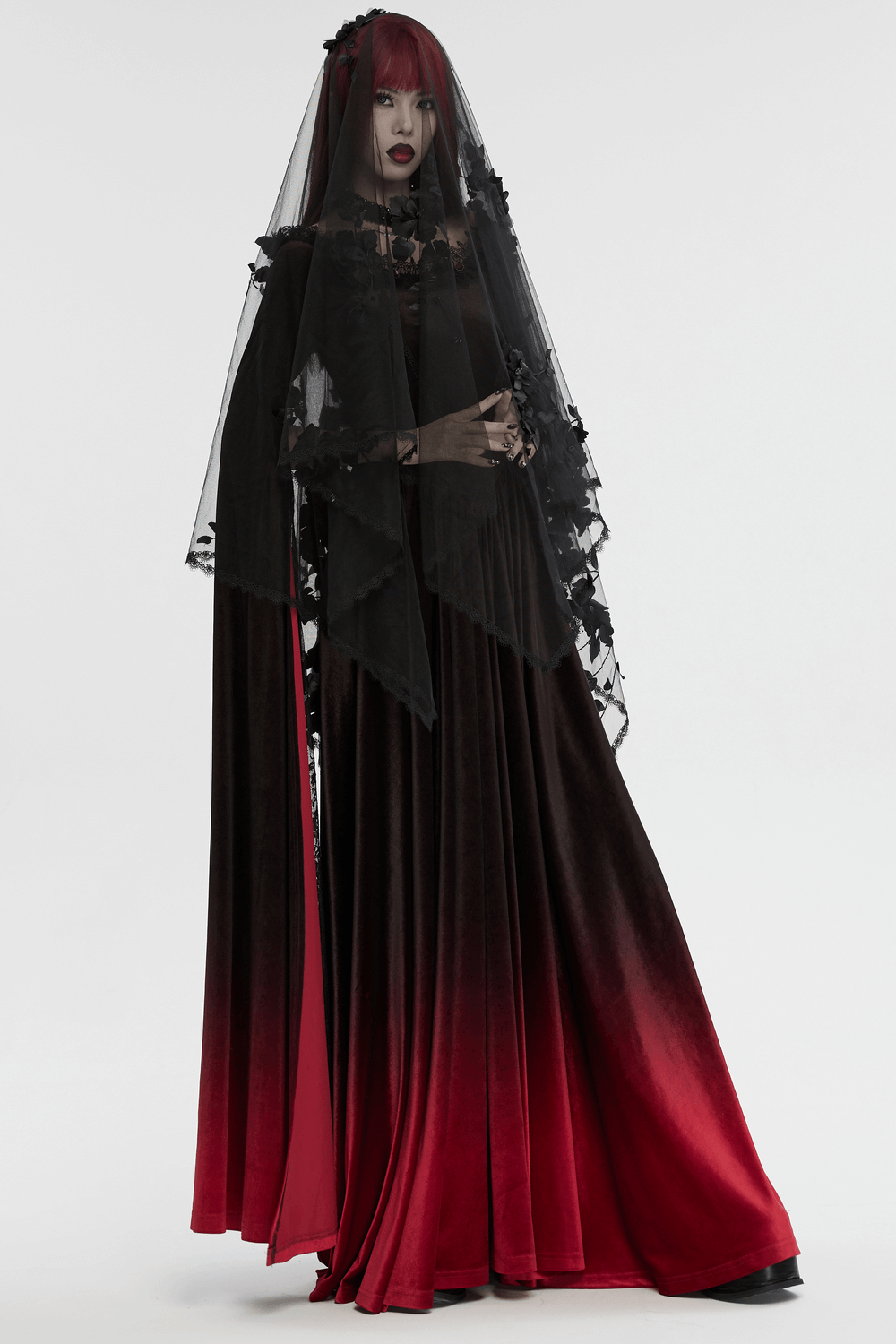 Women in a gothic 3D floral mesh veil with lace, wearing a black and red ombre gown for a hauntingly elegant look.