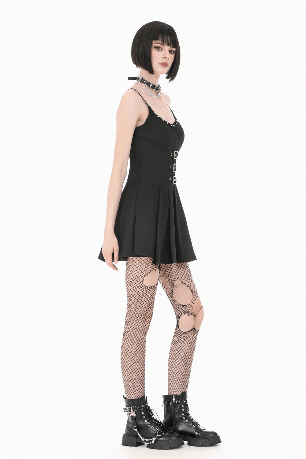 Women's Gothic Buckle Corset Mini Dress with Pleated Skirt, model wearing black dress with fishnet tights and chunky boots.