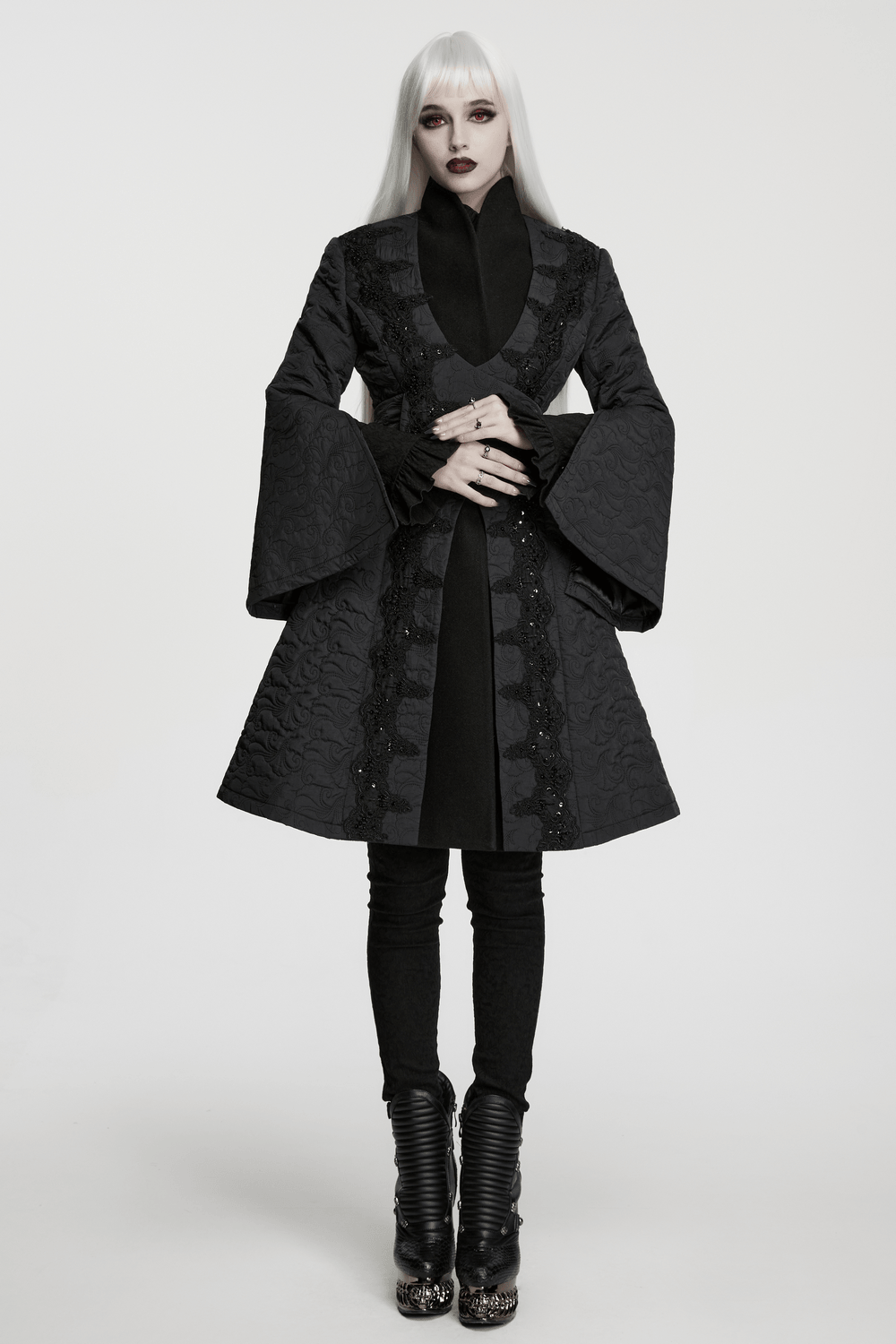 Women's Gothic Embroidered Black A-Line Victorian Coat modeled by a person with long hair and intricate black boots.