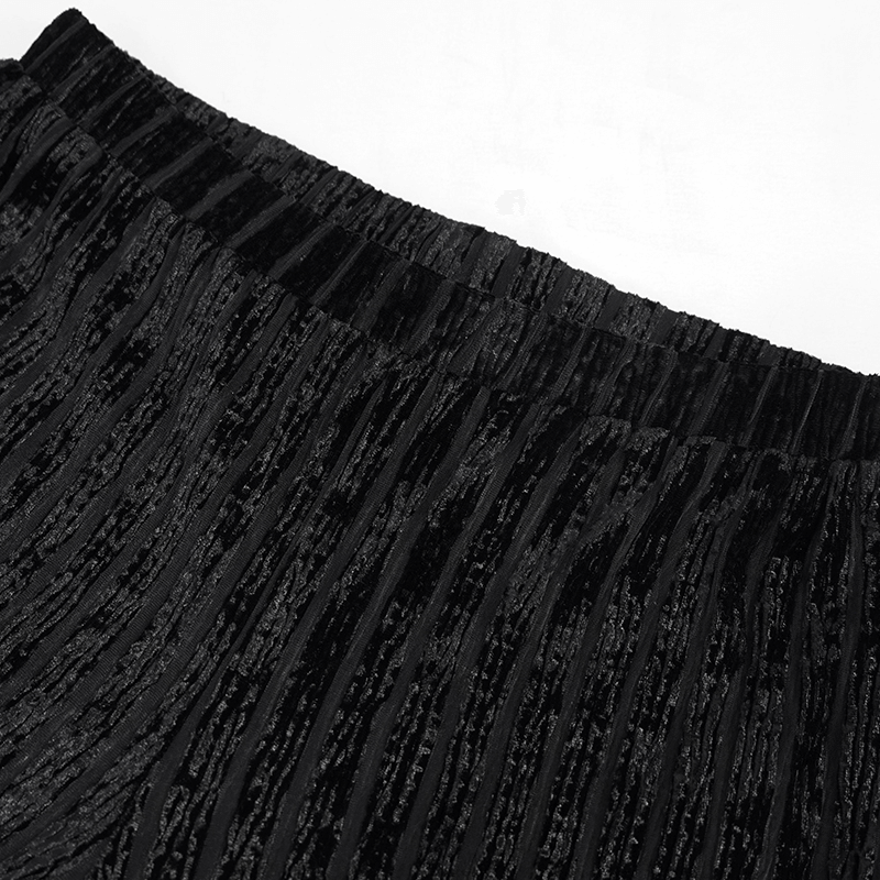 Close-up of women's gothic black flared pants showcasing textured fabric and elastic waistband.