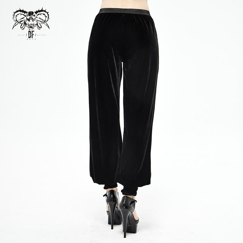 Back view of women's black velvet flared pants with elegant lace details, perfect for gothic vintage style.