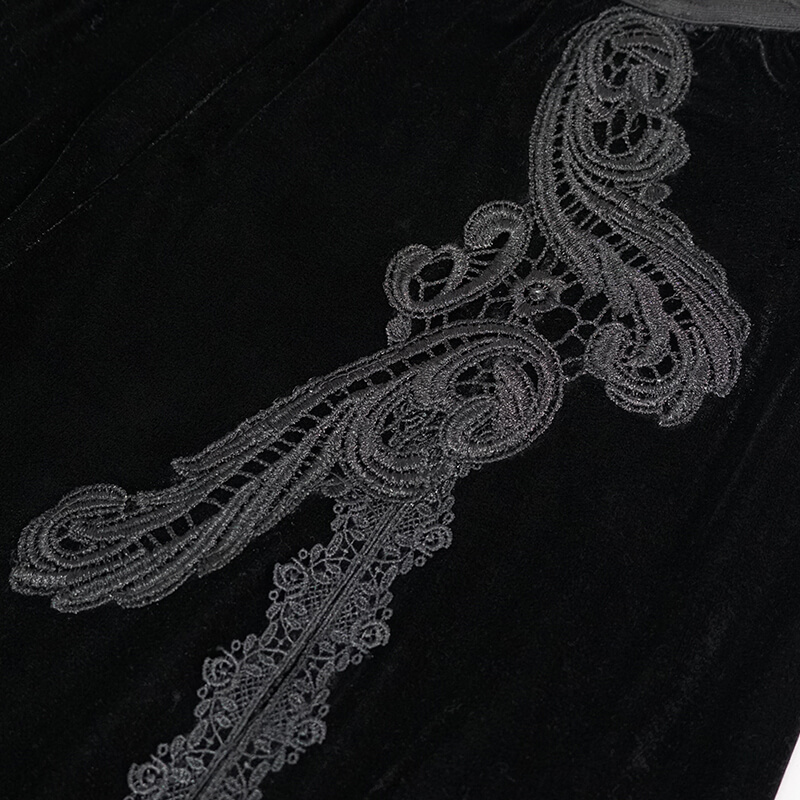 Close-up of elegant black velvet fabric with intricate gothic floral embroidery for women's flared pants.