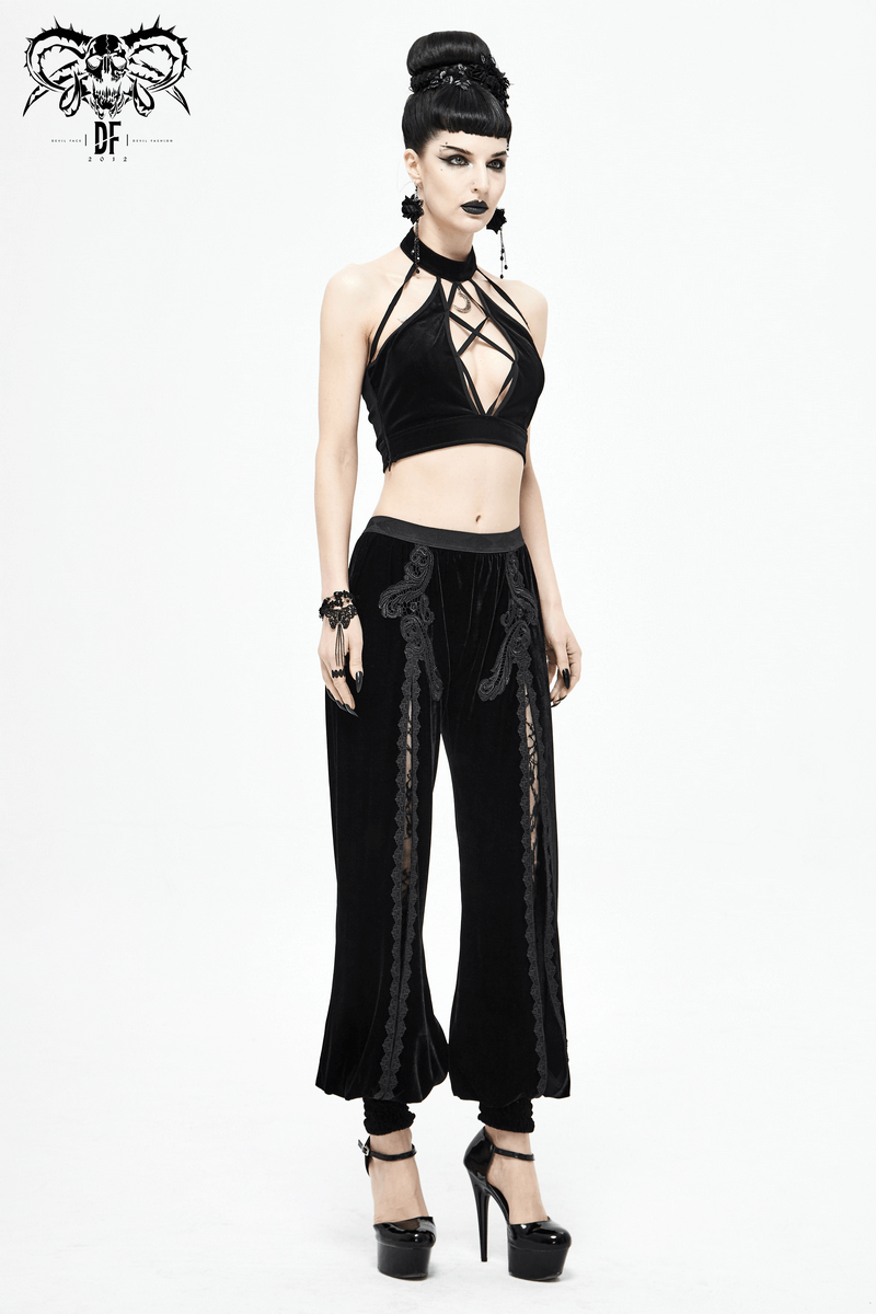 Model showcasing women's gothic floral embroidered black velvet flared pants with lace inserts, exuding elegance and style.