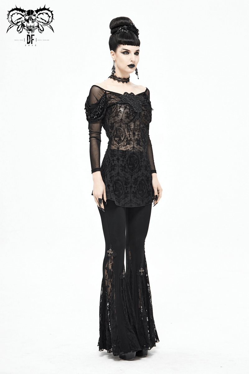 Elegant woman in a gothic floral embroidered sheer black lace top paired with long black pants, showcasing a luxurious style.