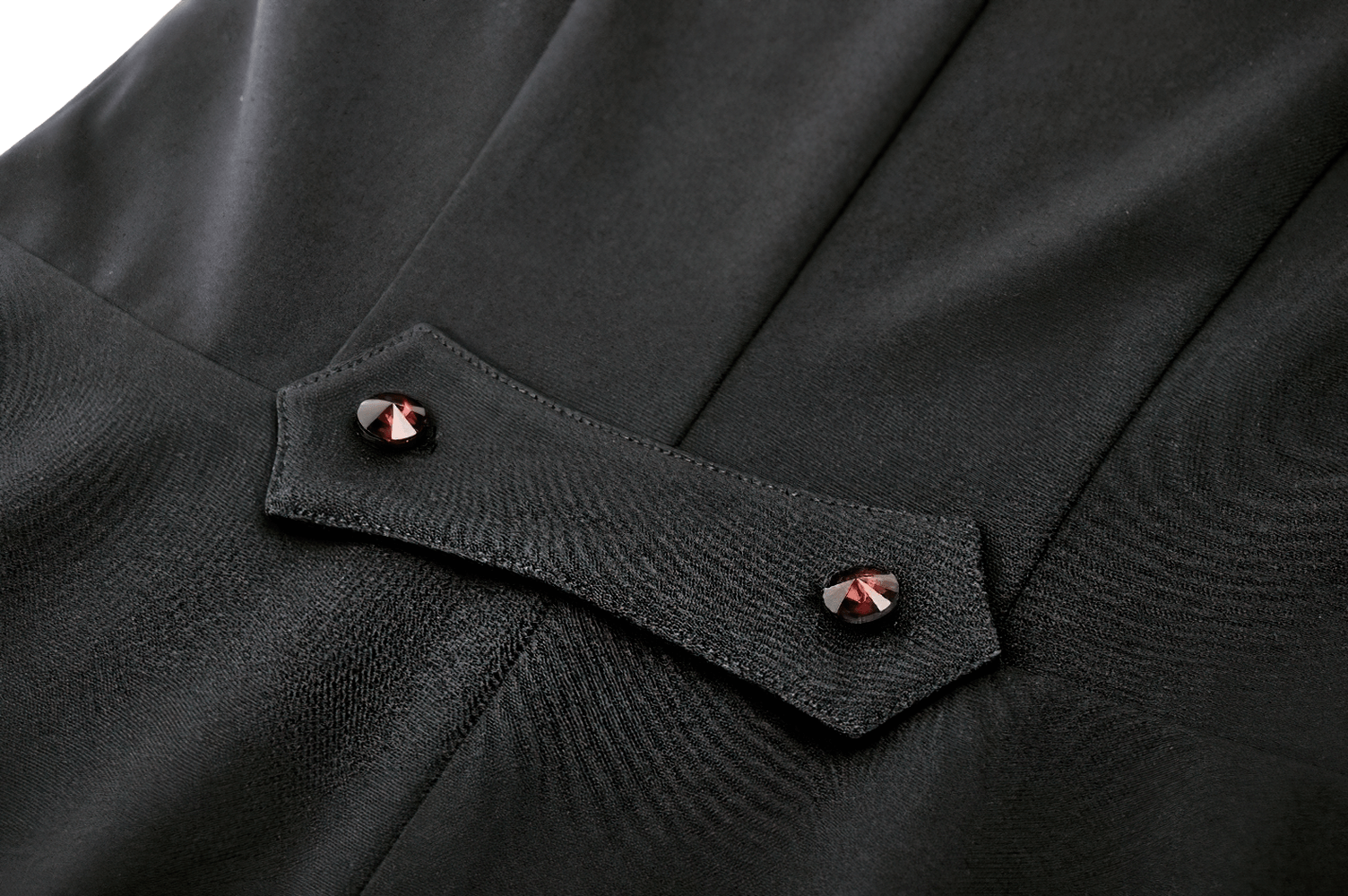 Close-up of the black ruffled detail and contrasting red buttons on a women's gothic high-low dress.