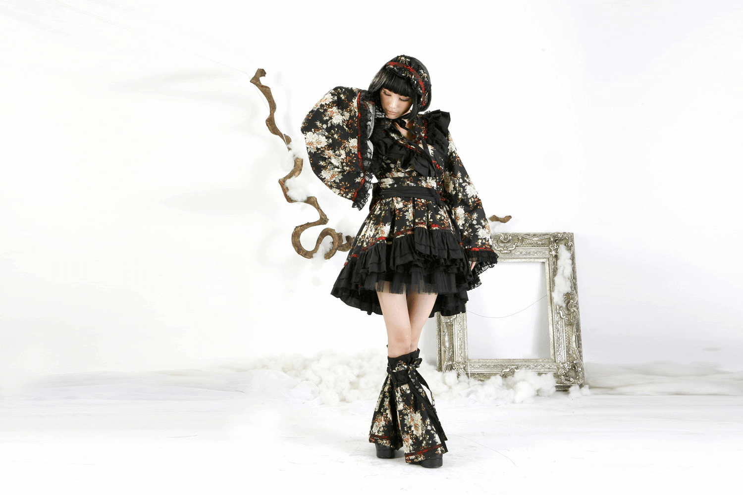 Model wearing a Women's Gothic Floral Lolita Dress with ruffles and lace, showcased in a vintage-inspired setting.