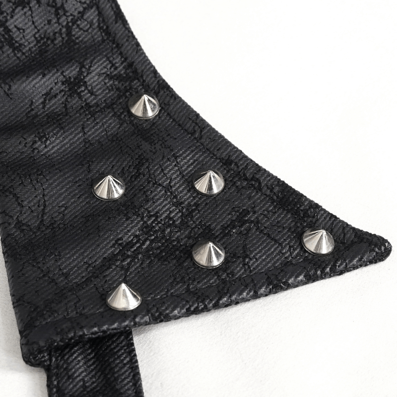 Close-up of black lace fabric with silver pyramid studs on a gothic waistcoat, showcasing intricate design details.