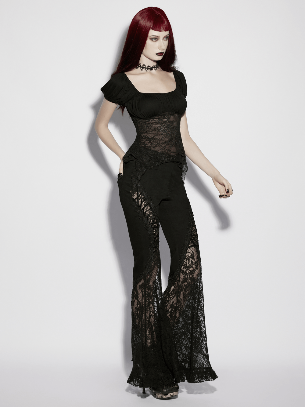 Women's Gothic Lace Handkerchief Hem Puff Top paired with lace flared pants for an edgy gothic look.