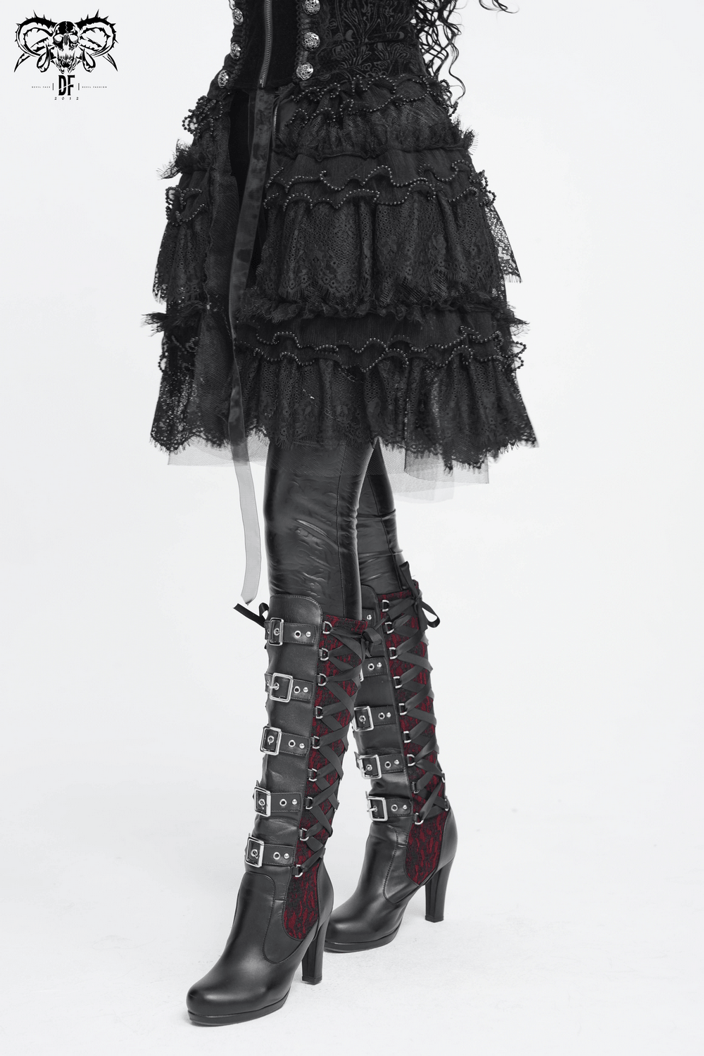 Women's Gothic Lace Ruffle Mini Skirt with Layered Trim paired with stylish knee-high lace-up boots.