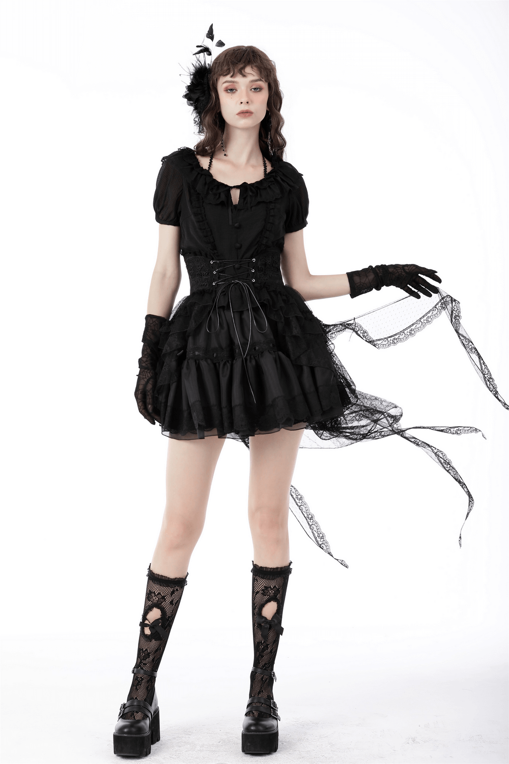 Model wearing a black gothic lace high-low skirt with lace gloves and stylish platform boots.