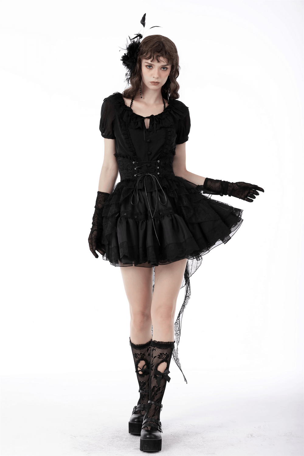 Model wearing a black gothic lace high-low skirt with delicate layers and stylish accessories, exuding dark elegance.