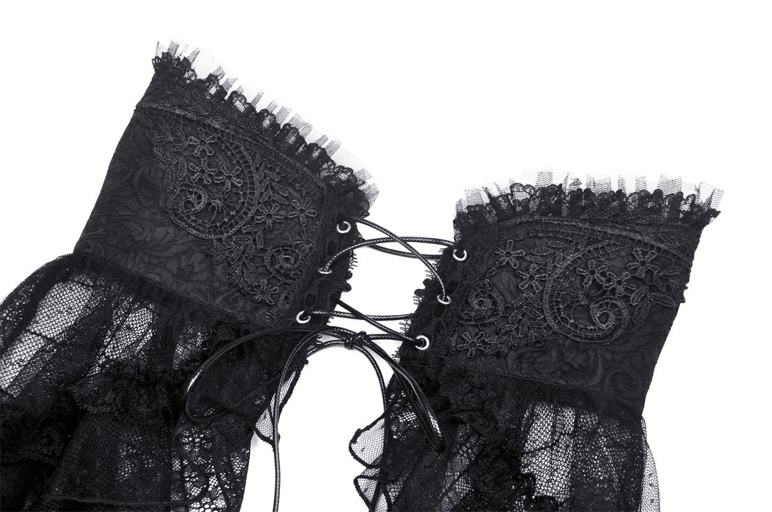 Close-up of intricate black lace detailing and corset lacing on a women's gothic skirt.