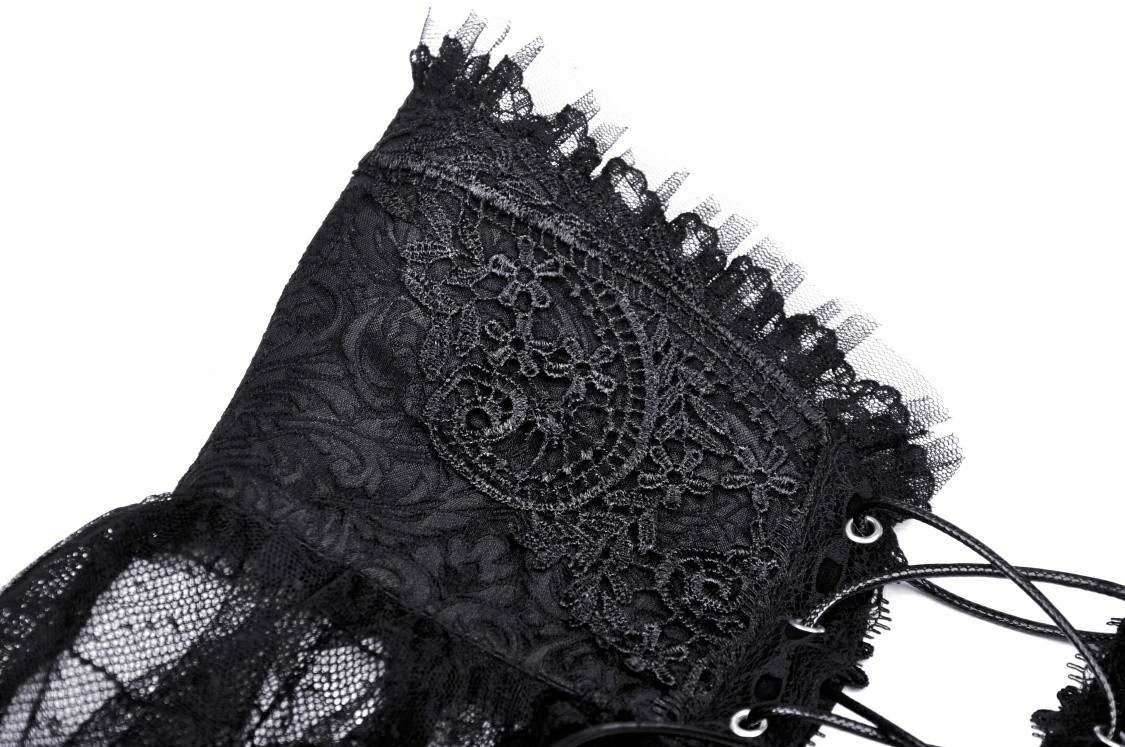 Close-up detail of intricate black lace and frill, showcasing gothic elegance in fashion.