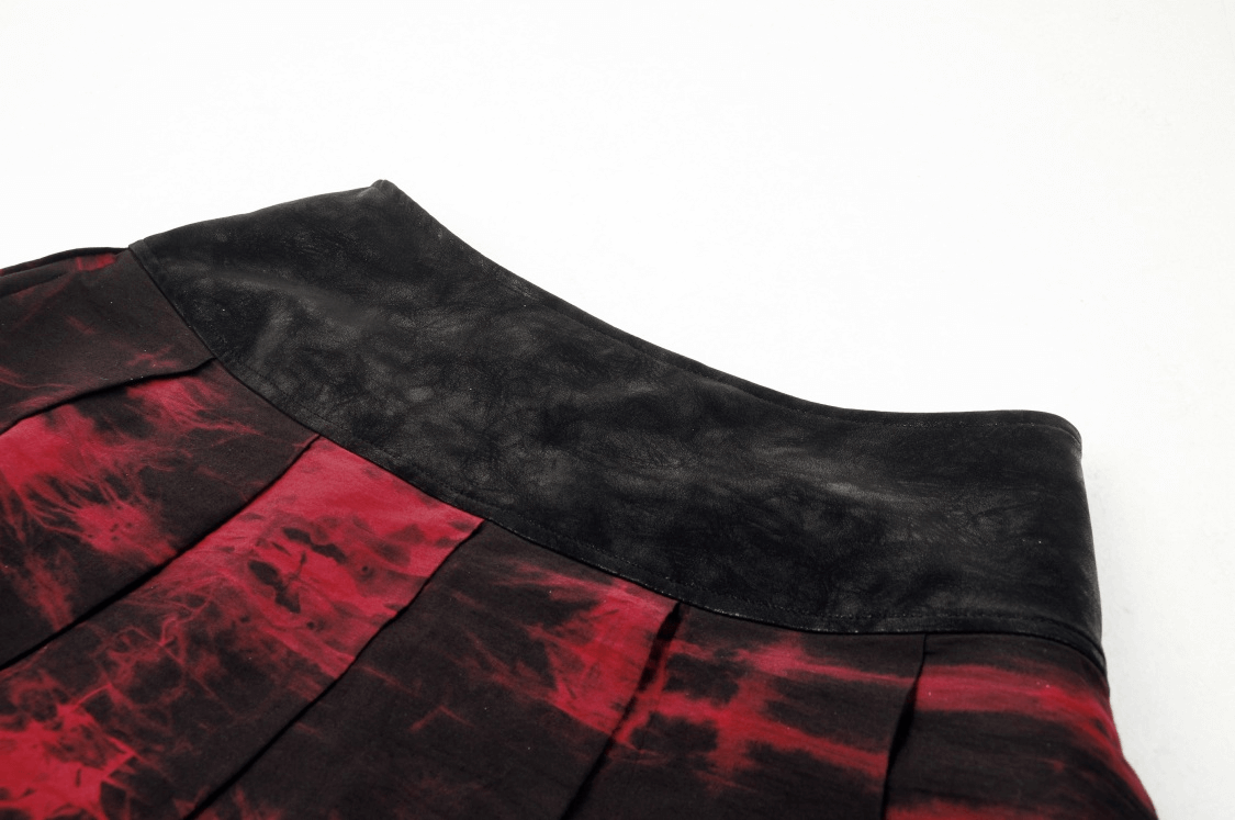 Close-up of a women's gothic mini skirt featuring a black waistband and wine-red marble pleats.