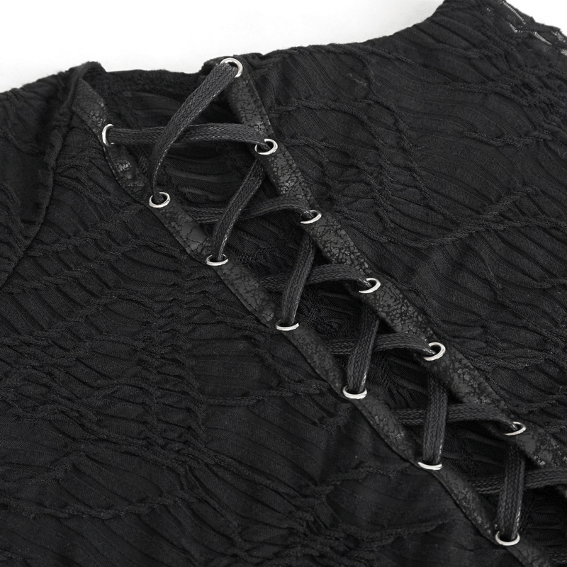 Close-up of black gothic patchwork top featuring lacing detail and textured fabric, perfect for alternative fashion.