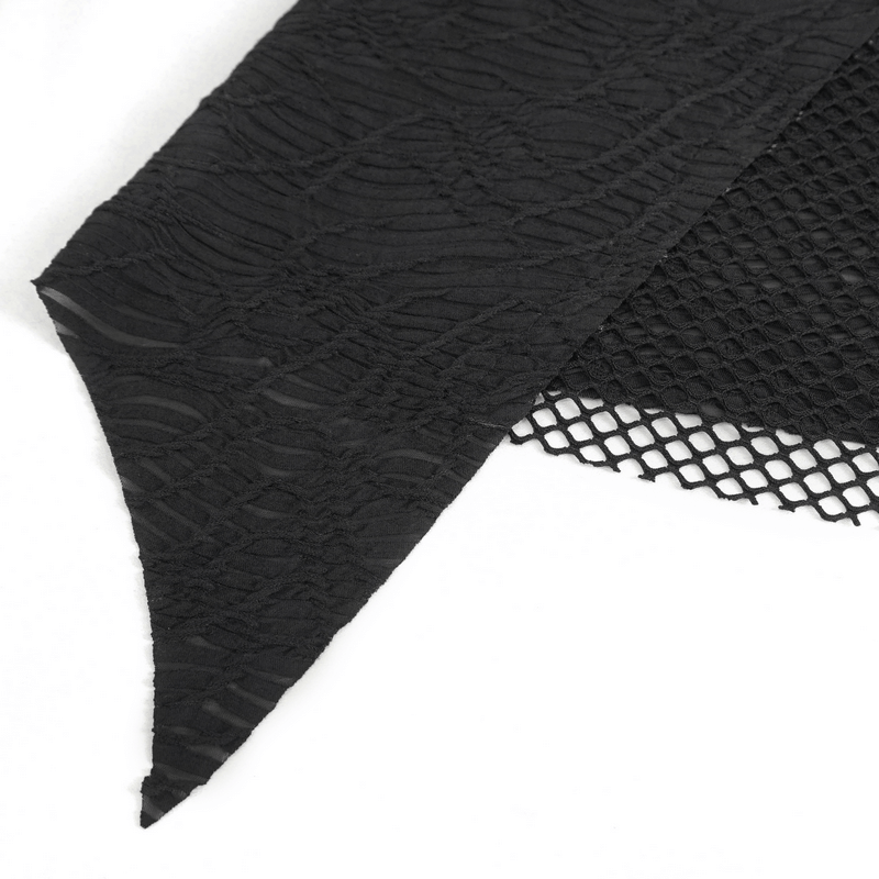 Close-up of women's gothic patchwork top featuring textured black fabric and mesh detail, showcasing an irregular hem.