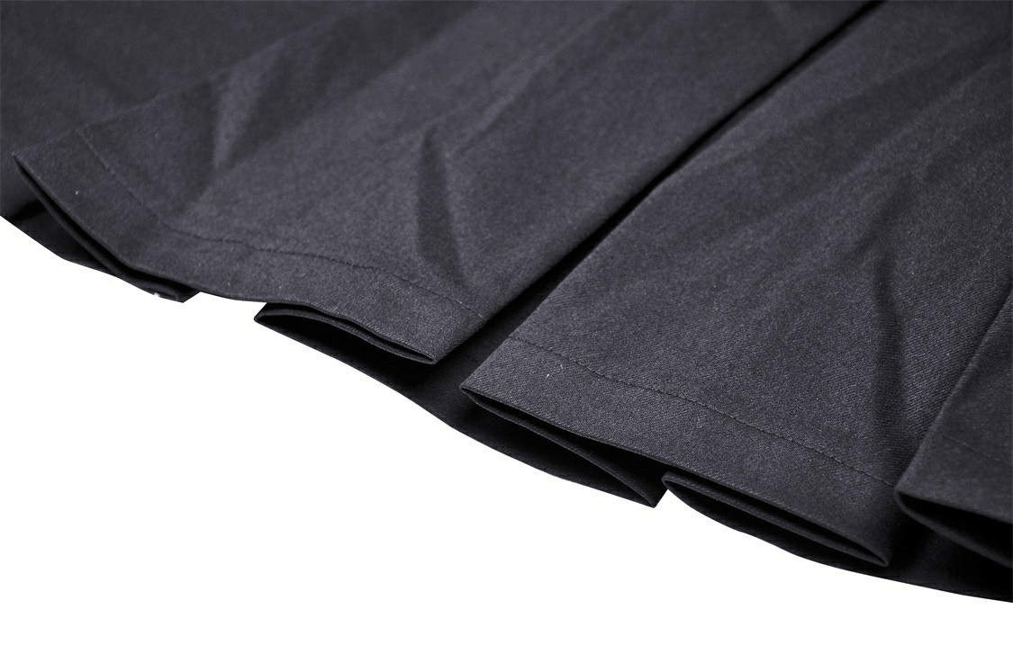 Close-up of the pleated hem of a black gothic skirt showcasing unique texture and style.