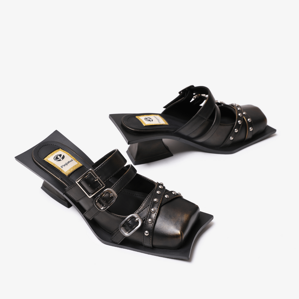 Women's Gothic Punk Buckle Strap Studded Heeled Mules in black with square toes, silver studs, and sculptural heels