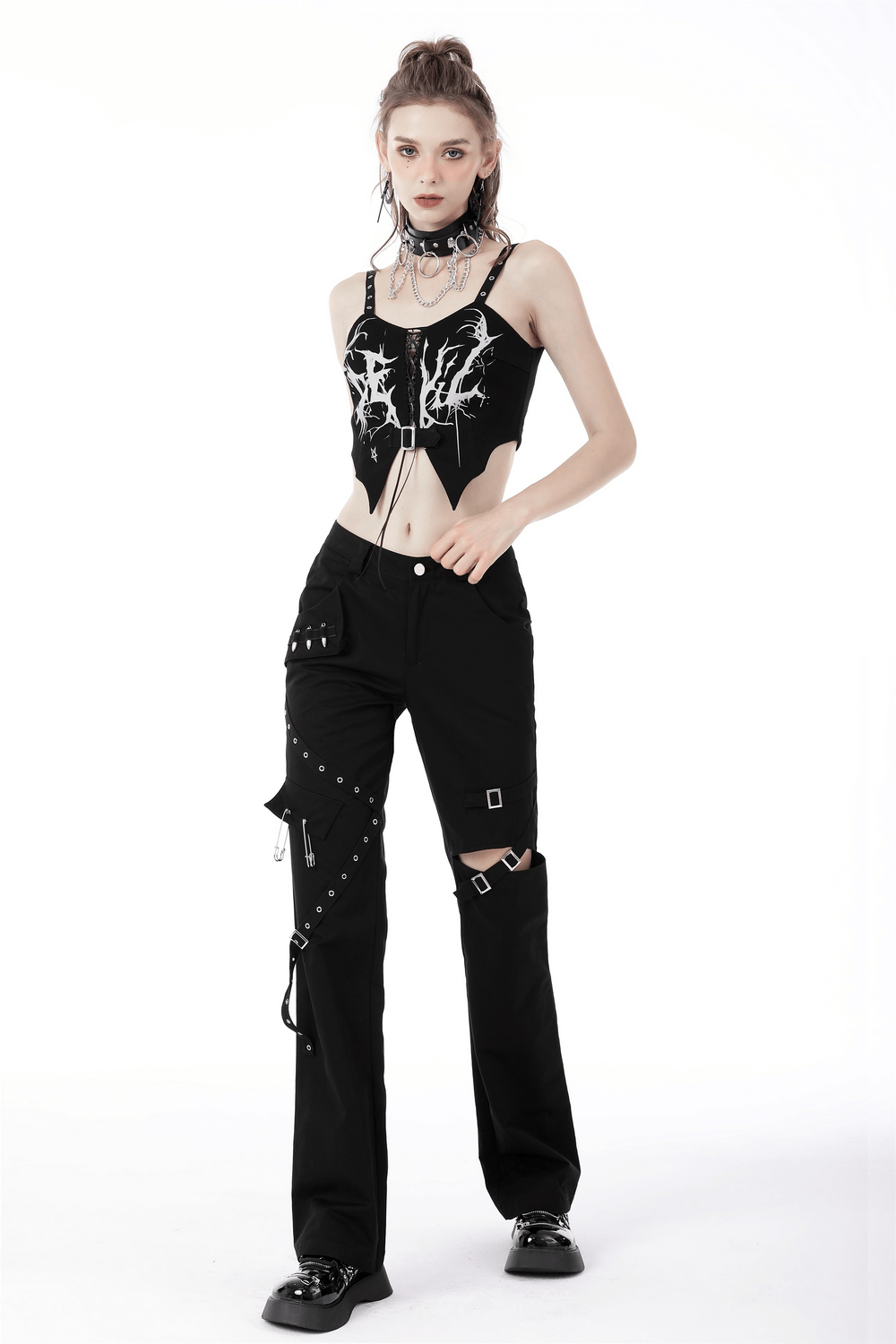 Edgy woman in gothic punk crop top and black pants with stylish details showcasing unique fashion style.