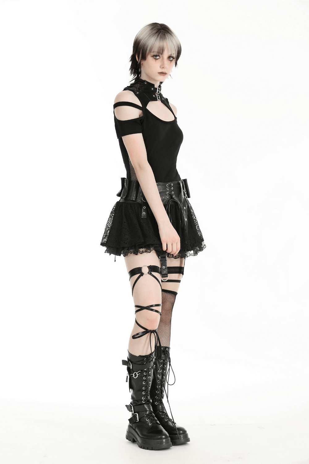 Edgy women's gothic punk outfit featuring black mesh cutout top, layered skirt, and knee-high lace-up boots.