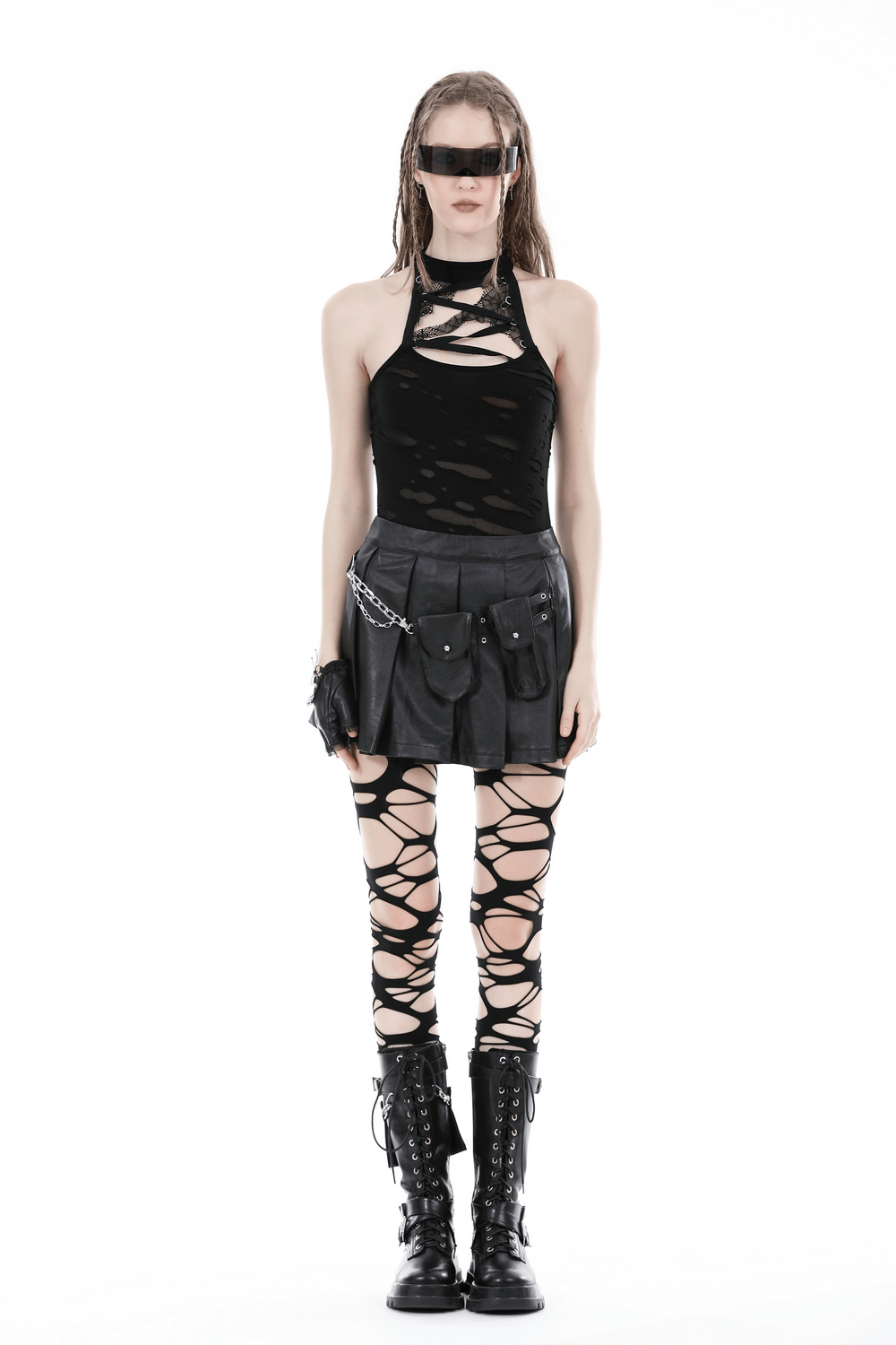 Edgy model in black Gothic punk mini skirt with chain, paired with ripped top and laced leggings for a bold, rebellious look.