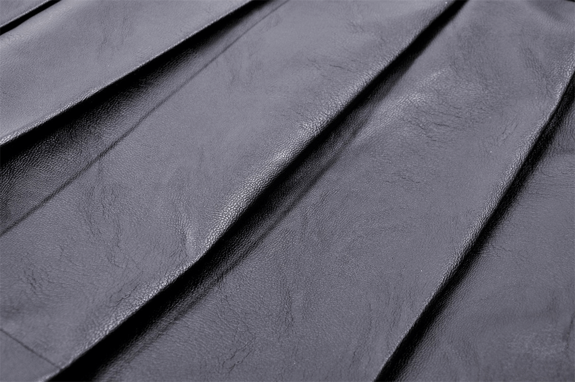 Close-up of pleated black fabric showcasing the edgy texture of a women's gothic punk mini skirt.