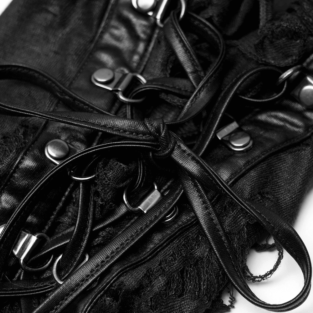 Close-up of black gothic strappy leg warmers with decorative loops and ribbons for adjustable fit.