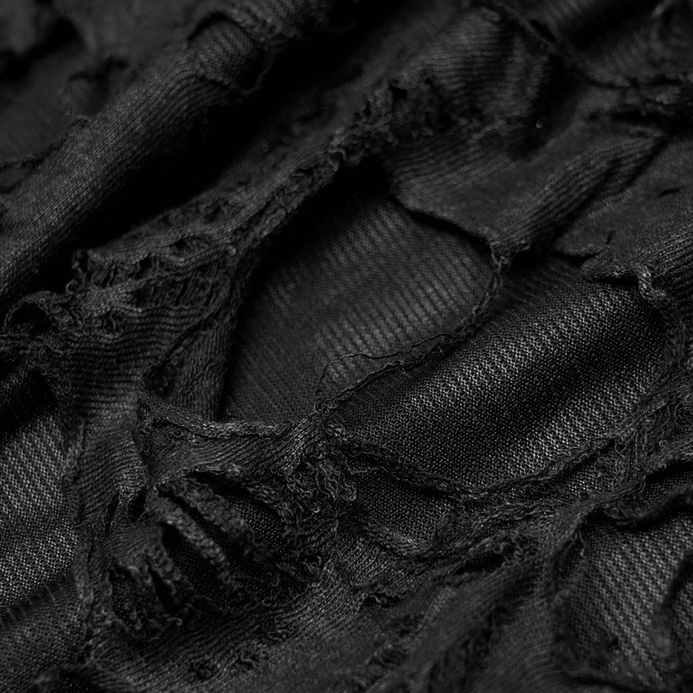 Close-up of black ripped fabric showcasing gothic style, perfect for women's long strappy leg warmers.