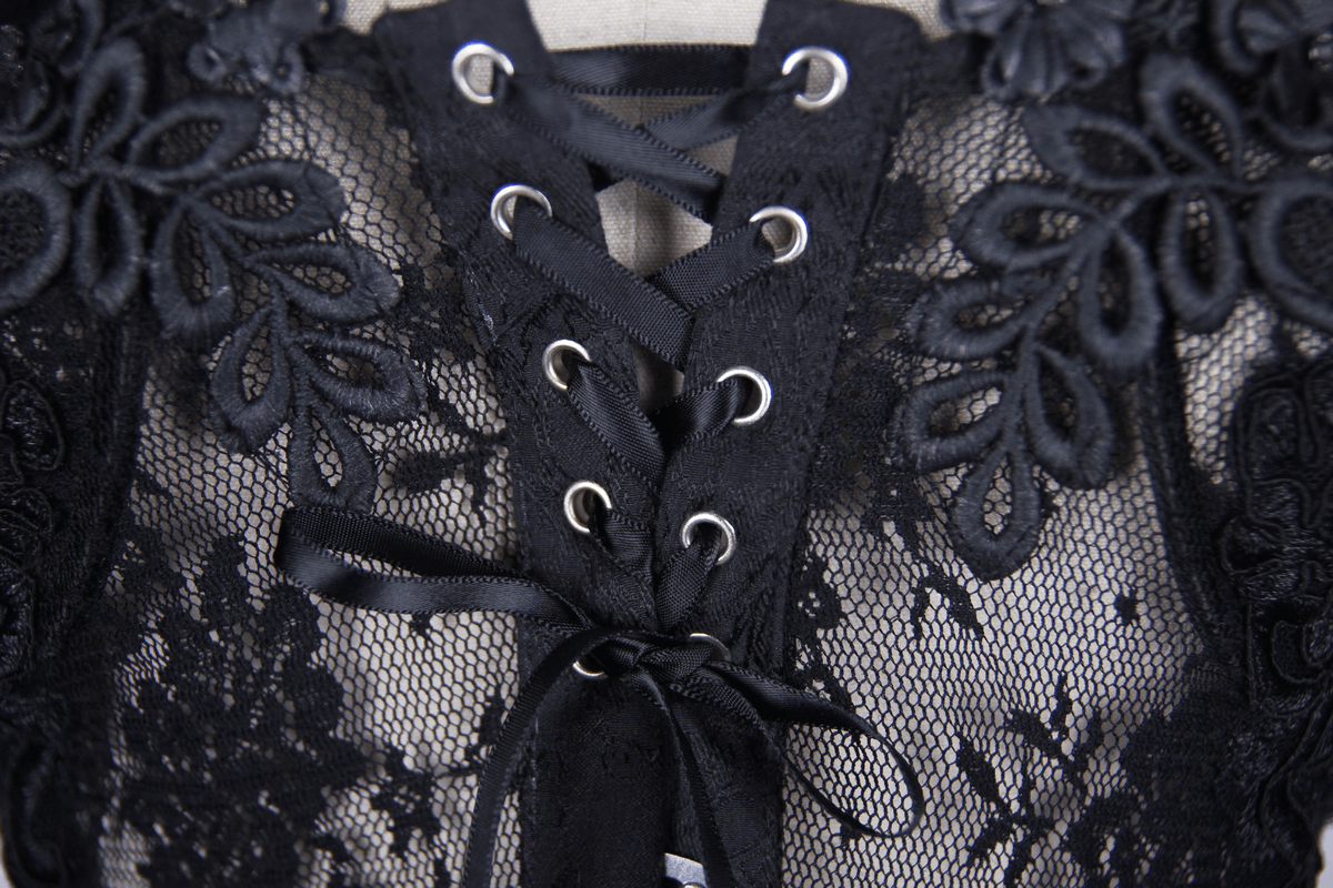 Close-up of women's gothic black lace corset with floral patterns and lace-up detail.
