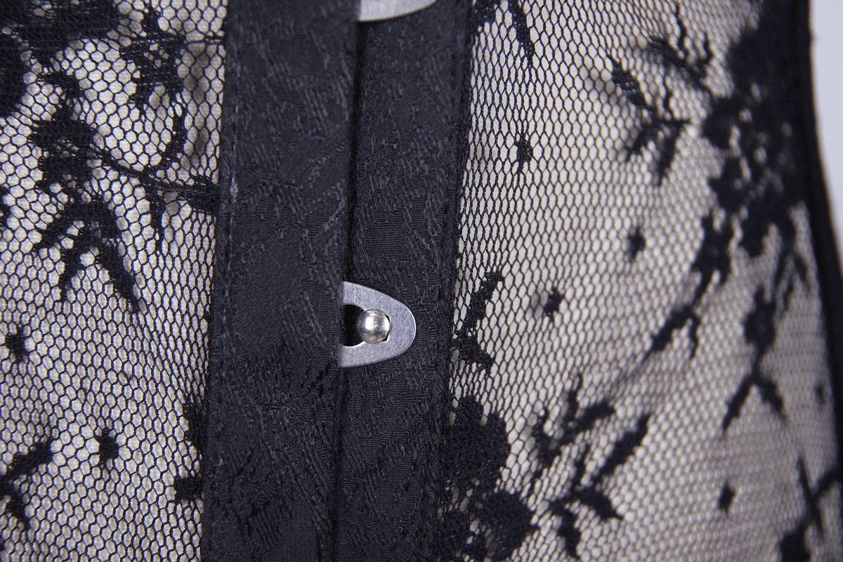 Close-up of black lace corset fabric, showcasing intricate lace patterns and stylish buttons.