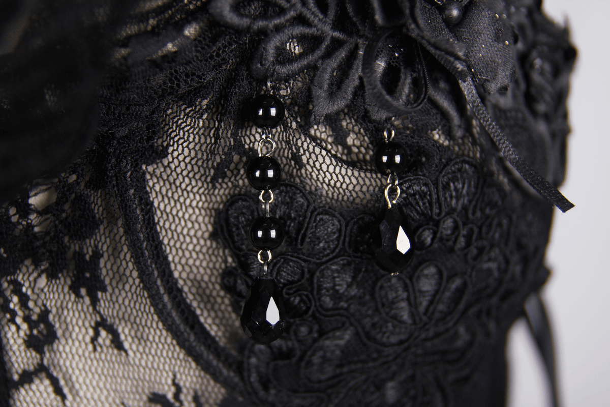 Elegant black lace corset detail featuring beads and floral patterns with stunning transparent fabric.