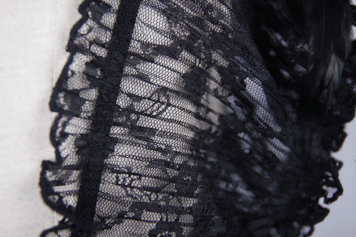 Close-up of black lace fabric with intricate patterns and ruffled edges, perfect for gothic corsets.