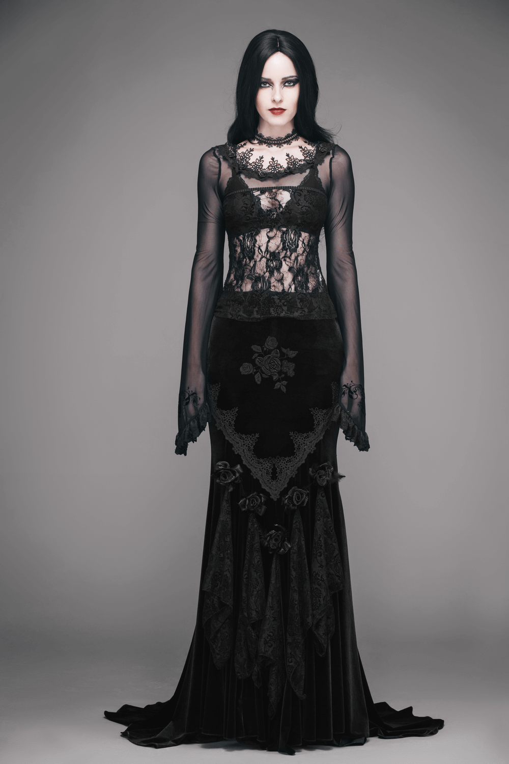 Elegant gothic woman wearing a black lace corset dress, showcasing transparency and vintage floral designs.