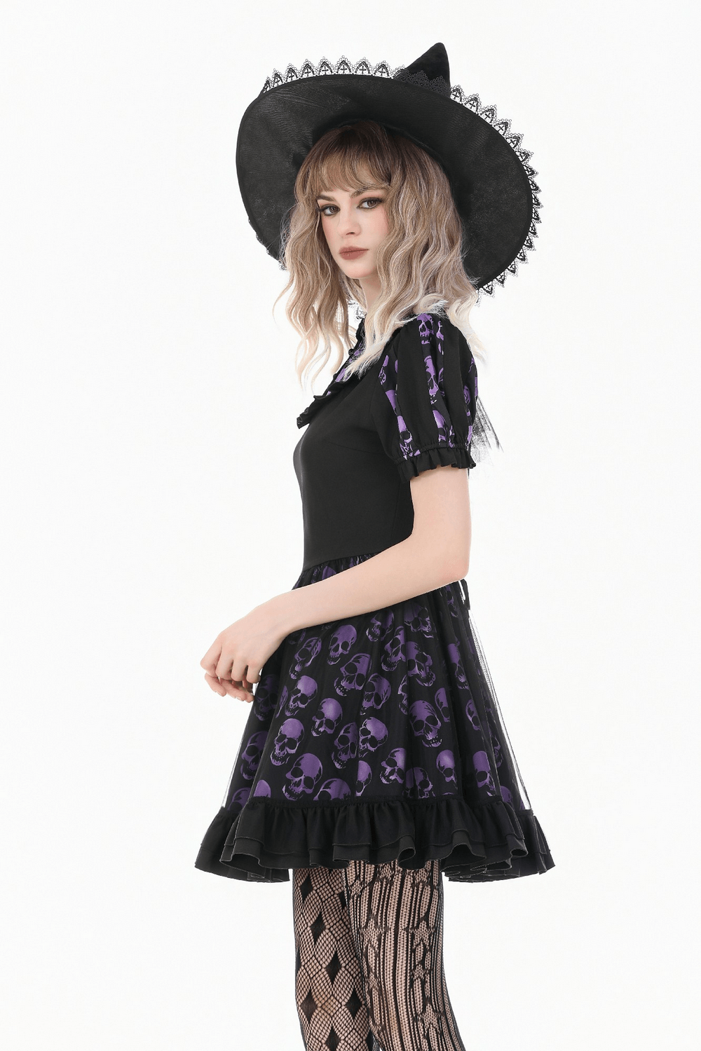 Women's Gothic Skull Print Mini Dress with Puff Sleeves worn by a model in a witch hat and patterned tights.
