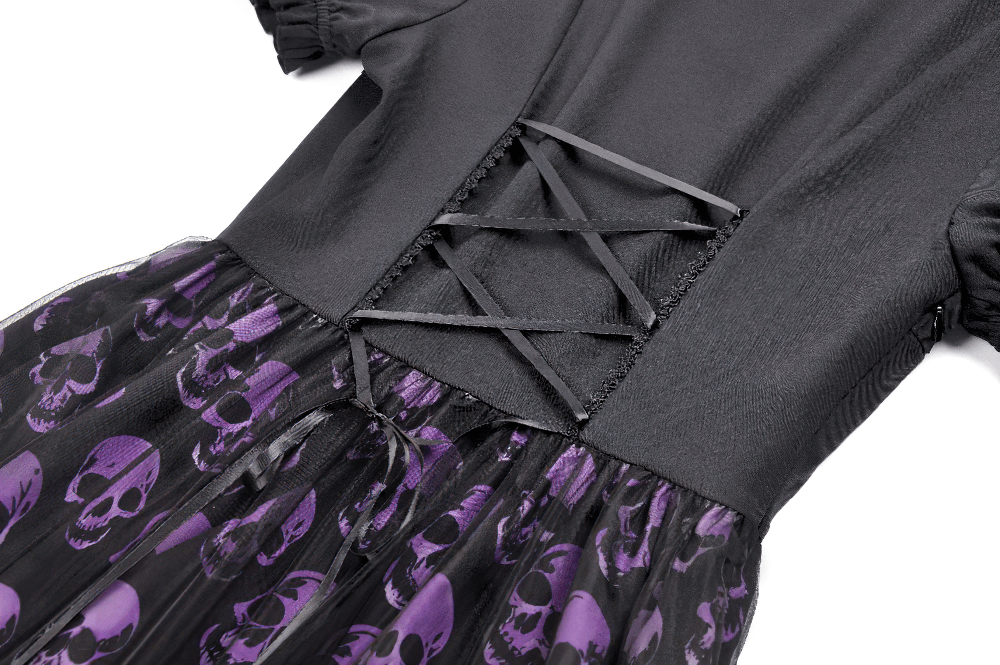Close-up of Women's Gothic Skull Print Mini Dress with Puff Sleeves showcasing laced back and purple skull pattern.