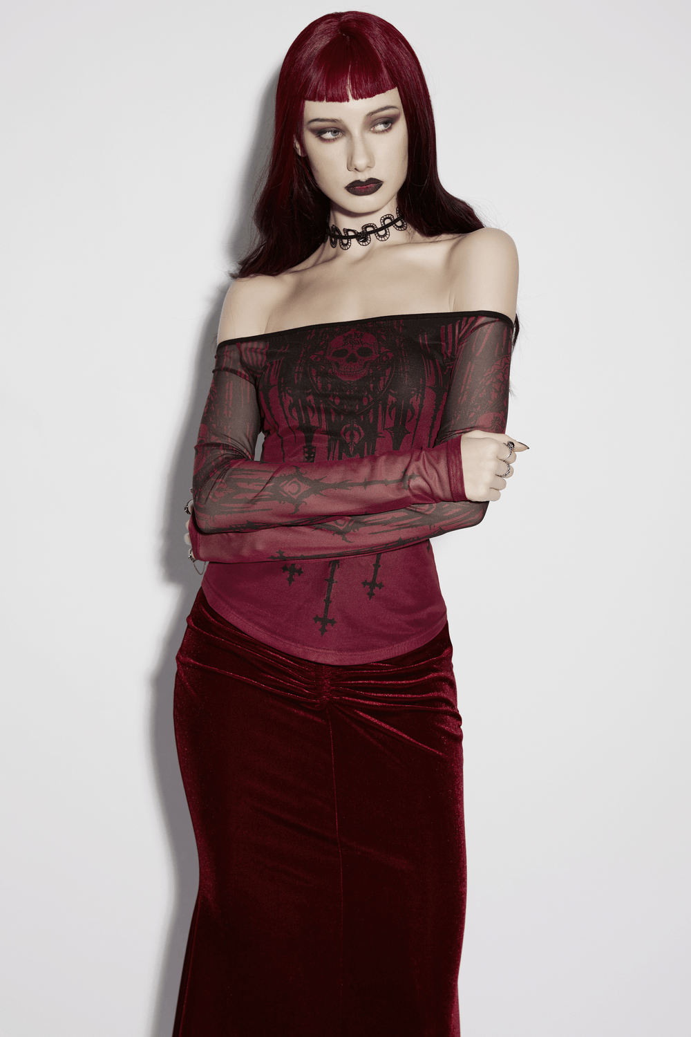 Women's Gothic Skull Print Off Shoulder Mesh Top styled with a red velvet skirt, showcasing a gothic aesthetic.