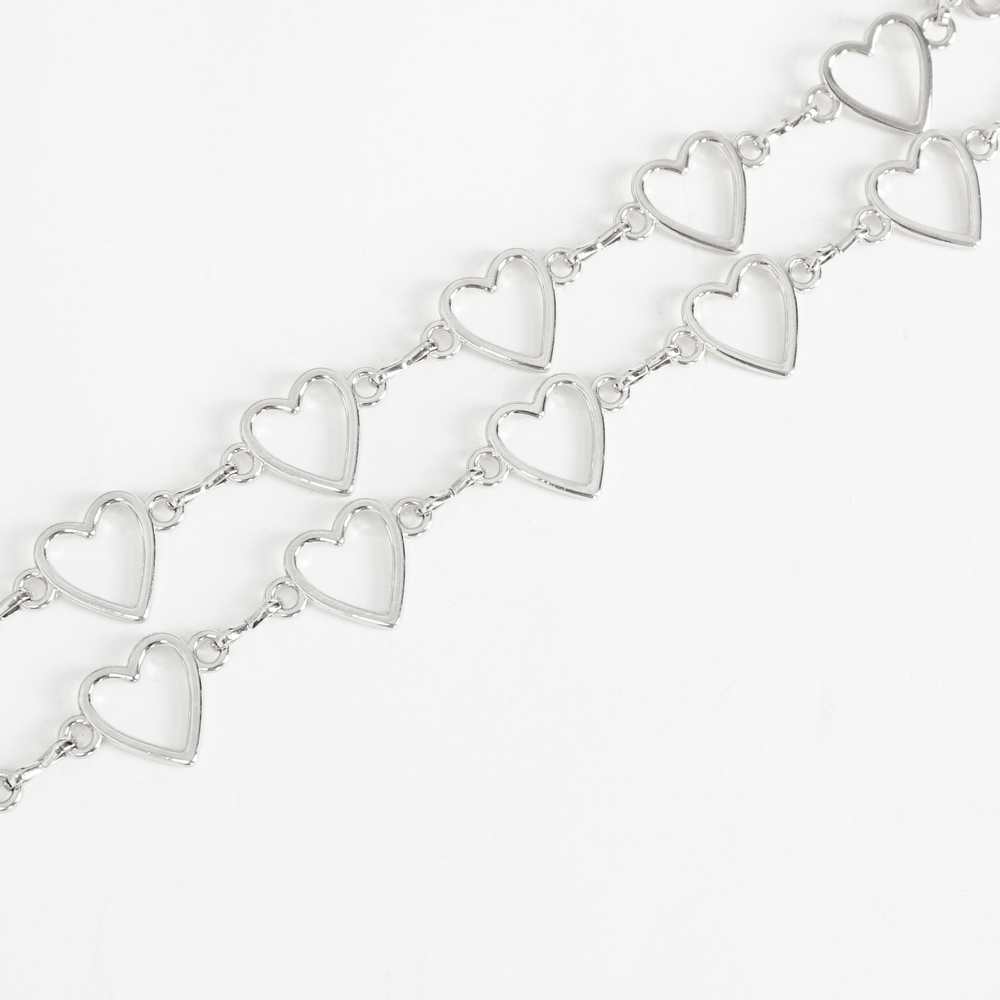 Silver heart chain bracelet with open heart charms, perfect for adding a romantic touch to any outfit.