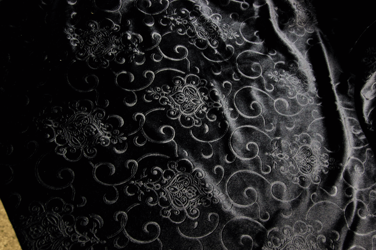 Elegant black fabric with intricate gothic embroidery patterns, perfect for stylish flared trousers.