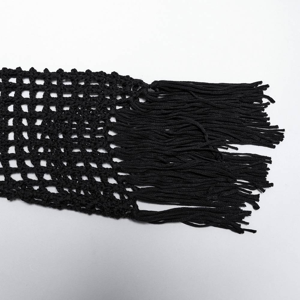 Black tassel fringe detail of a gothic knit sweater showcasing a hollow design and edgy style.