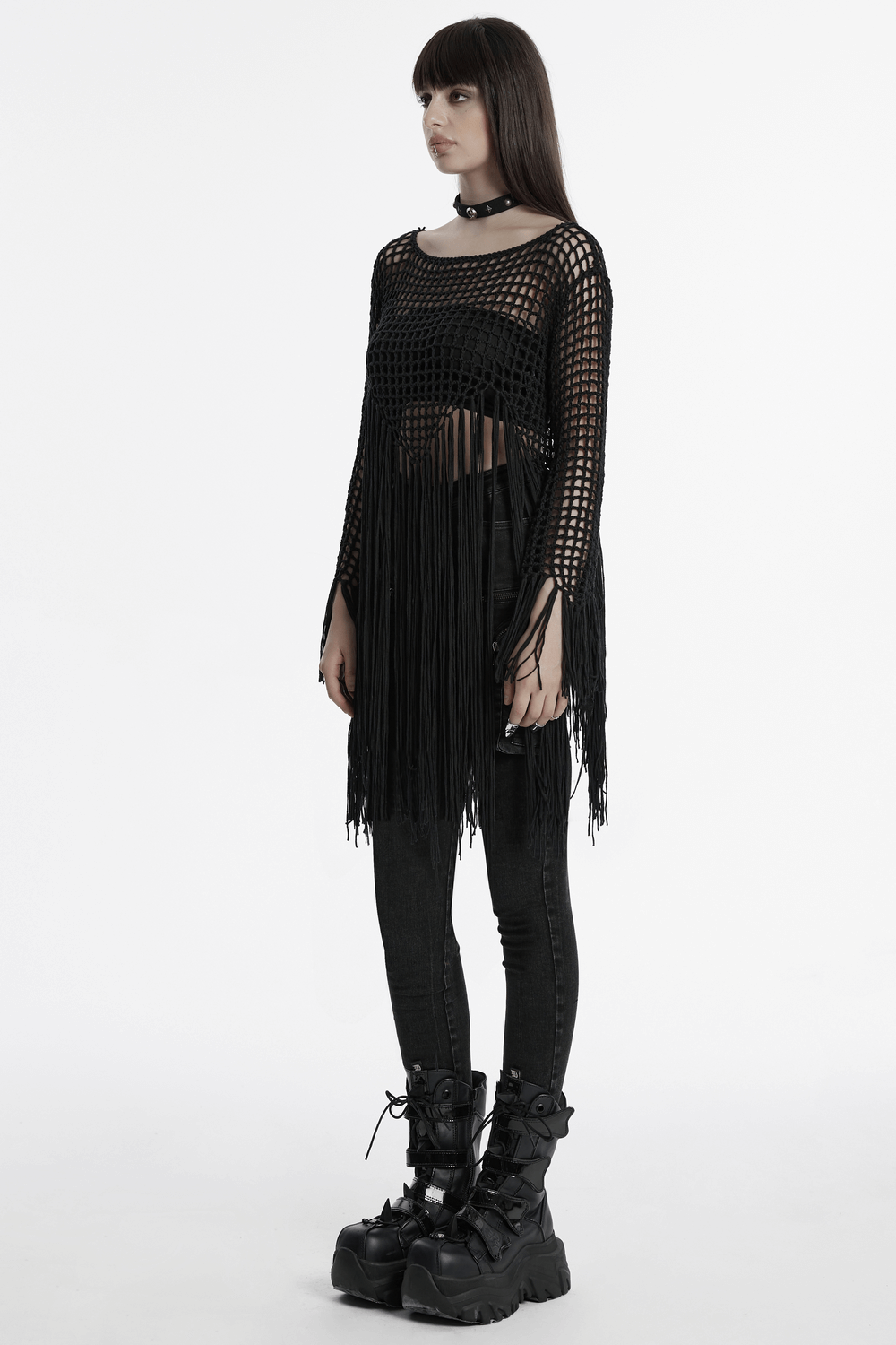 Black gothic tassel sweater dress with fringe detail, styled with chic black pants and edgy combat boots.