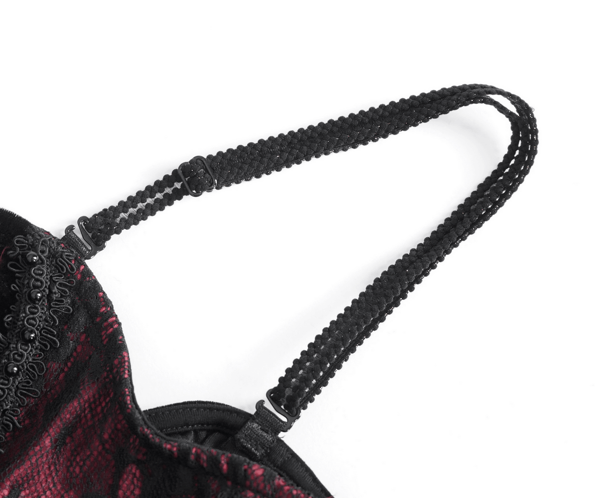 Close-up of a black lace strap from a women's gothic velvet dress, showcasing intricate detailing and adjustable buckle.
