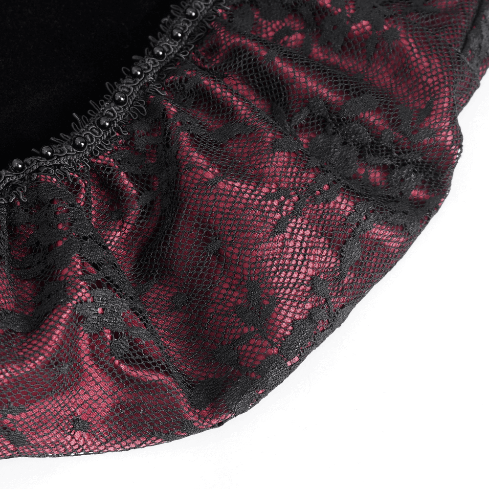 Close-up of burgundy floral lace appliques on elegant gothic velvet dress, showcasing intricate details and textures.